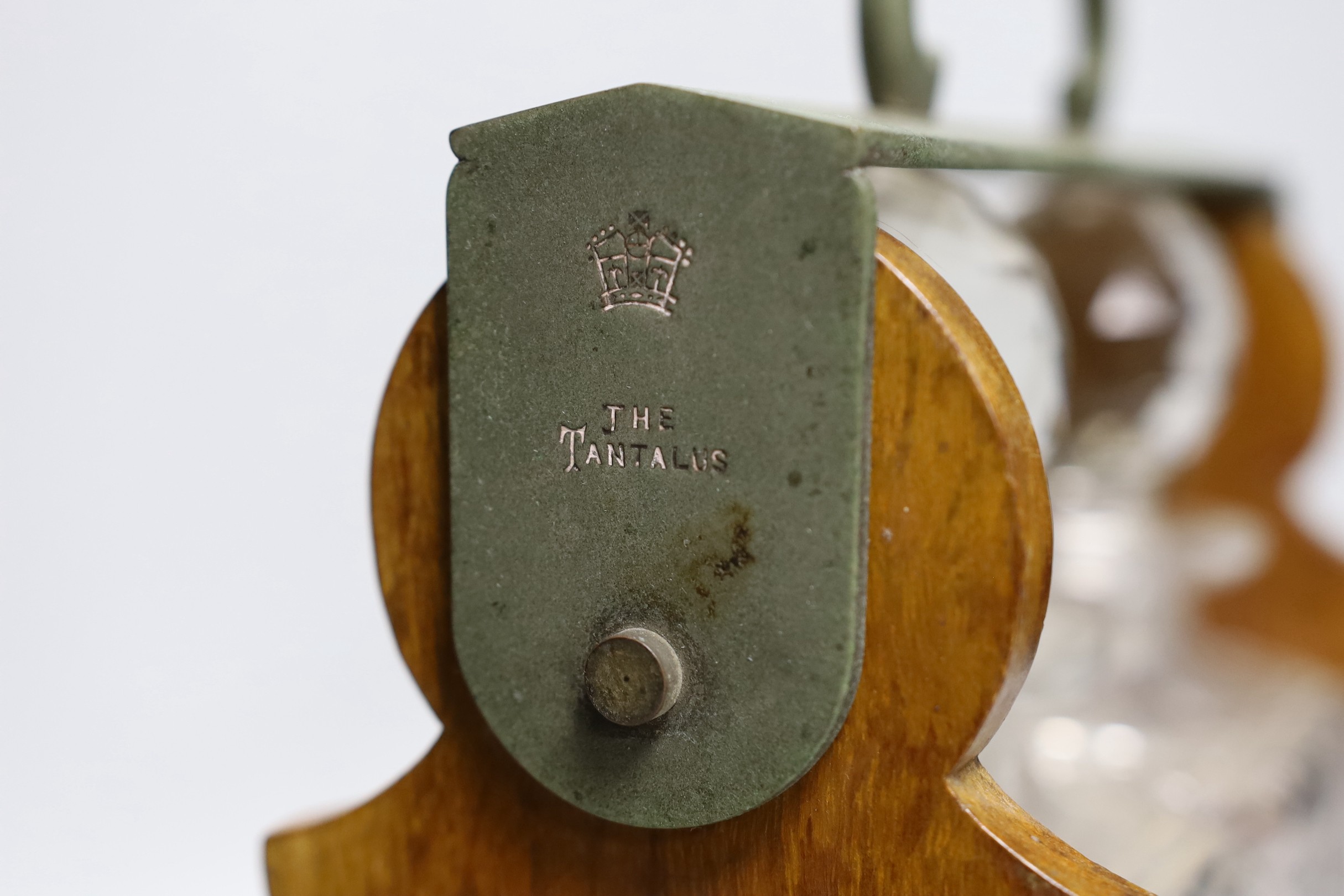 An Edwardian Betjemann’s Patent two bottle oak tantalus, 17cms wide
